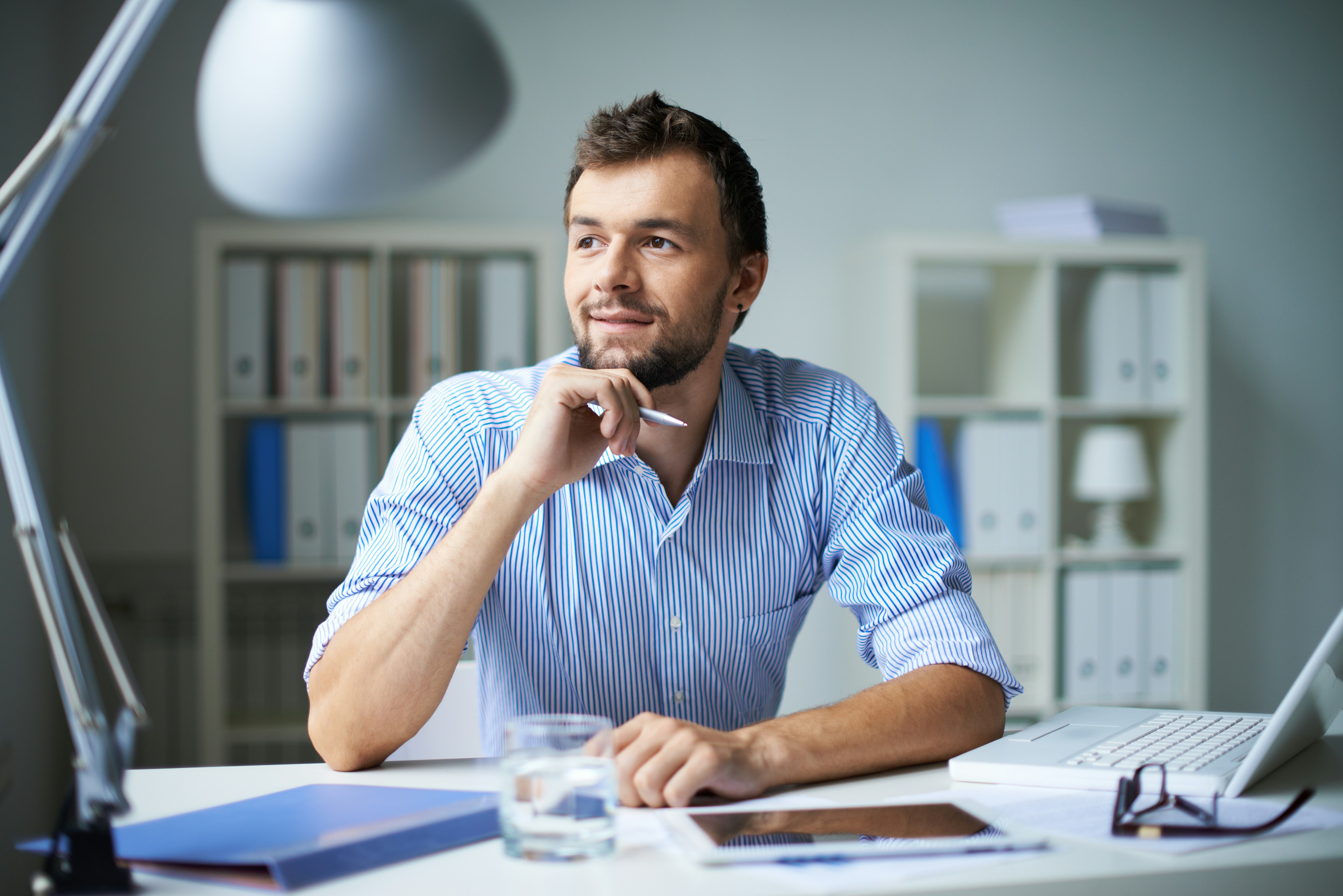 Smart businessman thinking about something in office