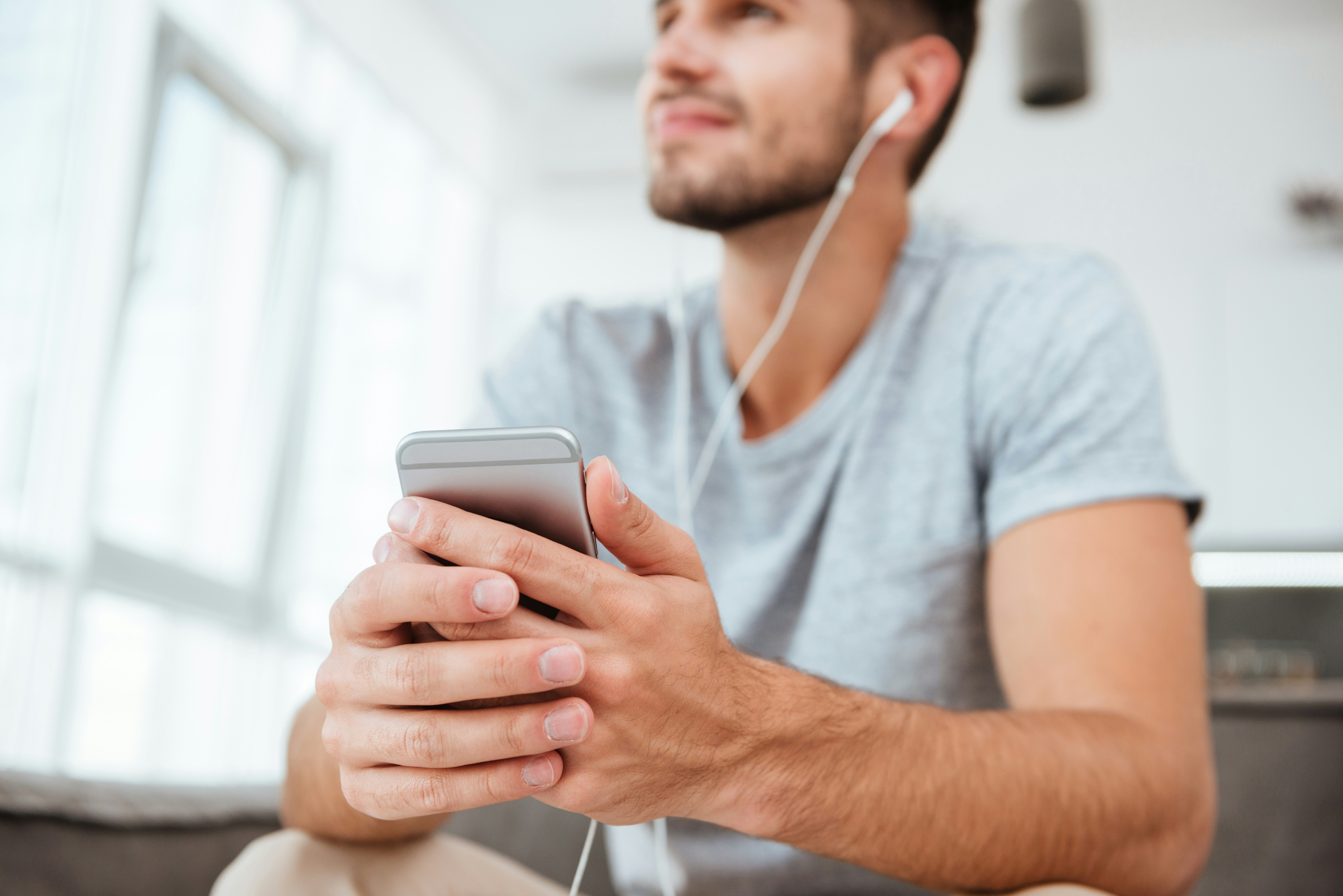 man listening to music on phone